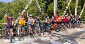 Picture of Cycle Connect 417's group on James River Iron Bridge in July 2023. (Source: Springfield Daily Citizen: https://sgfcitizen.org/springfield-culture/outdoors/women-on-wheels-cycle-connect-417-nurtures-camaraderie-and-community/)