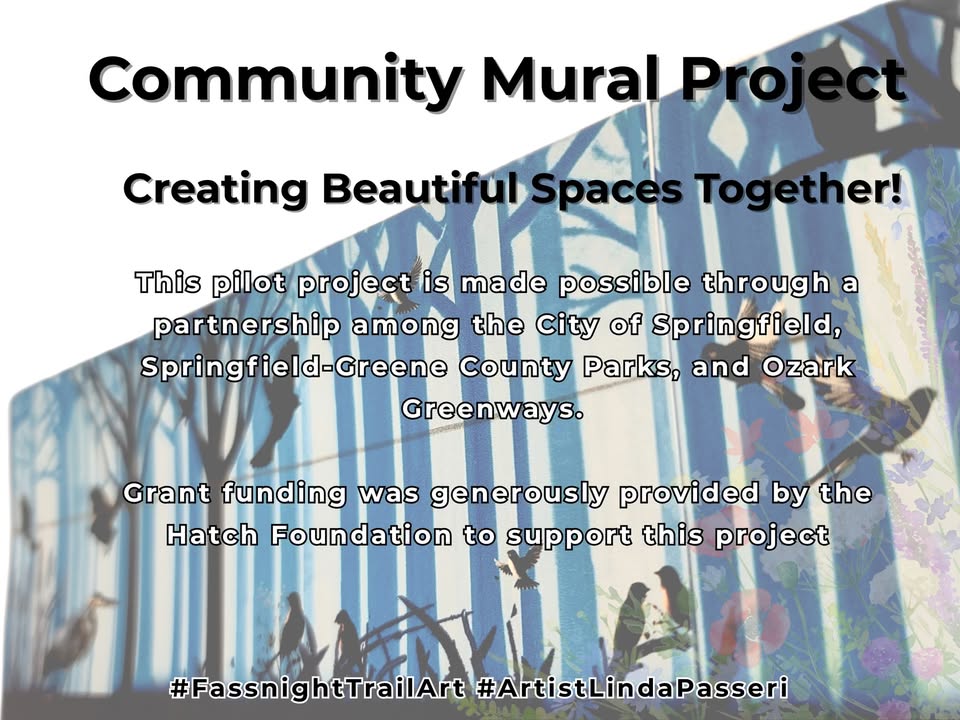 Picture of a mural showing a forest with blue trees and different birds. Text on the picture says: Community Mural Project - Creating Beautiful Spaces Together! This pilot project is made possible through a partnership among the City of Springfield, Springfield-Green County Parks, and Ozark Greenways. Grant funding was generously provided by the Hatch Foundation to support this project. #FassnightTrailArt #ArtisitLindaPasseri